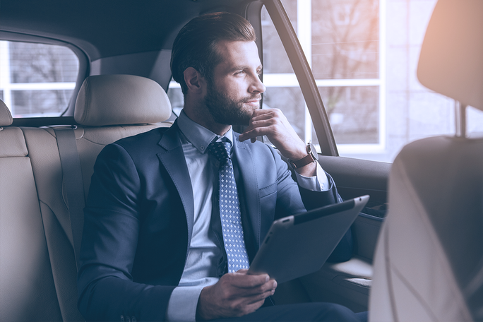 Muškarac je u automobilu i drži notepad